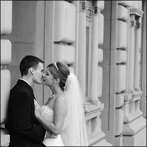 black and white image of bride and groom covered with bride's veil - testimonials photo